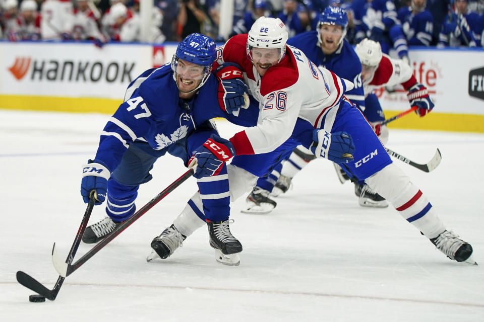 Toronto Maple Leafs forward Pierre Engvall (47) vies for the puck against Montreal Canadiens defenseman Jeff Petry (26) during the second period of an NHL hockey game Wednesday, Oct. 13, 2021, in Toronto. (Evan Buhler/The Canadian Press via AP)