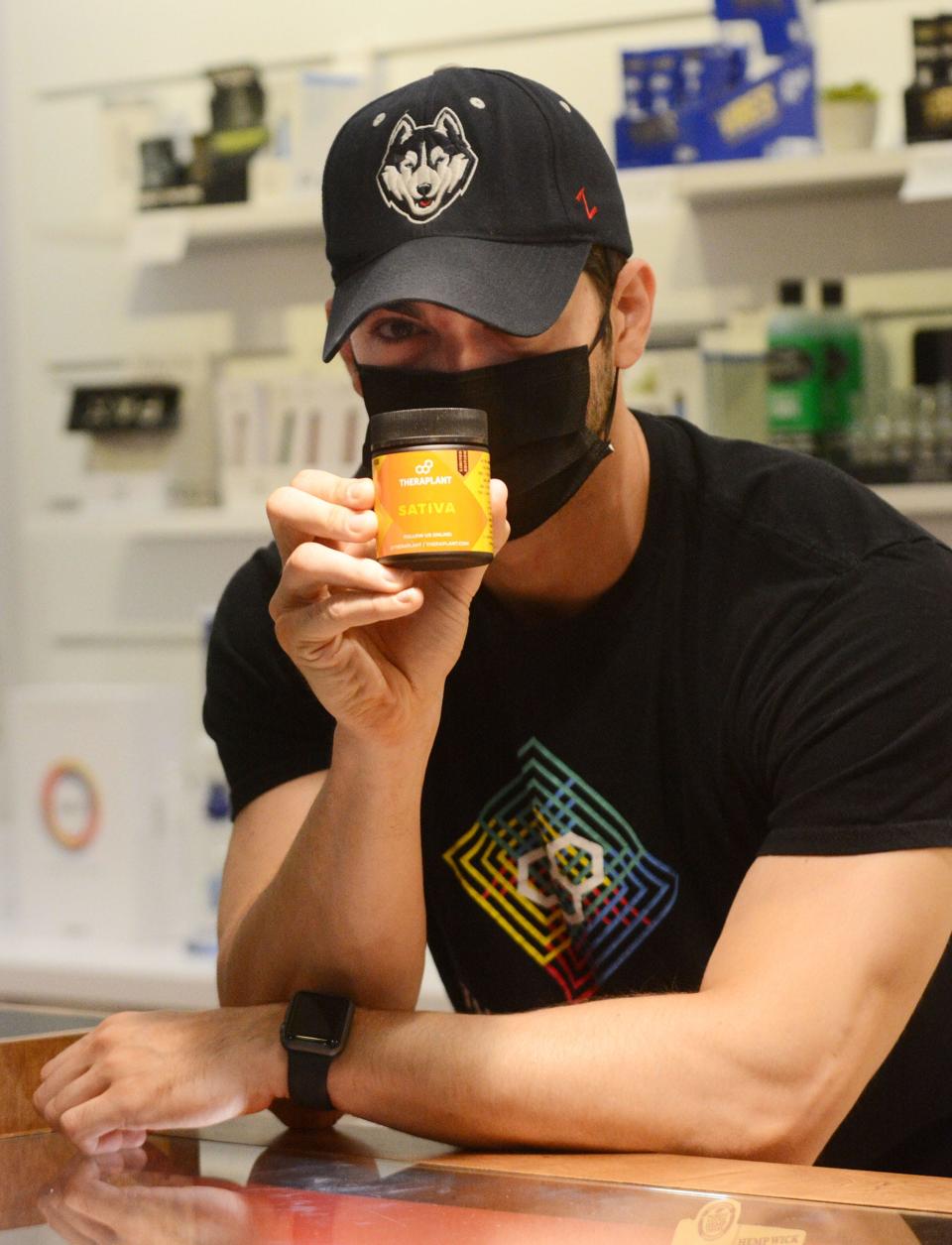 Shane Kelly, assistant manager and pharmacist at Fine Fettle medical marijuana dispensary, with Sativa, one of three major categories of marijuana flower available for medical marijuana patients at the Willimantic dispensary. File photo [John Shishmanian/ NorwichBulletin.com]