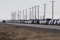 Motorists wait in line for the second dose of the Pfizer COVID-19 vaccine on Texas Loop 338 during the first day of the second dose vaccinations at the Ratliff Stadium Mass Vaccination Site on Tuesday, March 2, 2021 in Odessa, Texas. (Jacob Ford/Odessa American via AP)