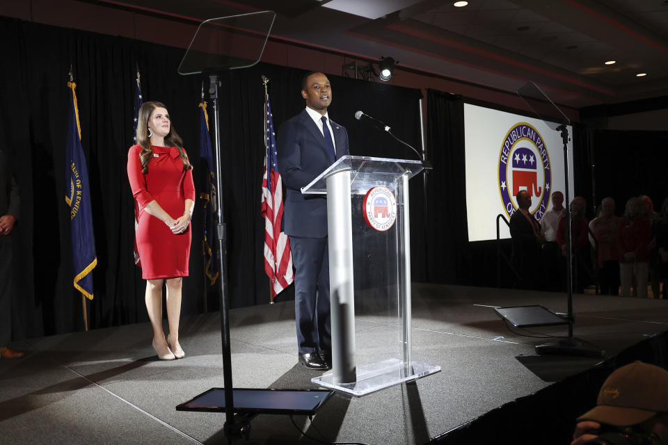 Republican gubernatorial candidate Daniel Cameron, middle, accompanied by his wife Makenze, left center, concedes to supporters during an election night watch party in Louisville, Ky., Tuesday, Nov. 7, 2023. (AP Photo/James Crisp)