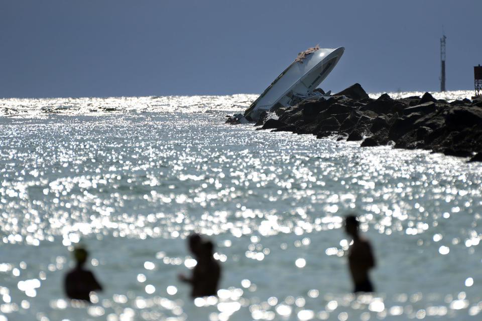 <p>An overturned boat lies on a jetty, Sunday, Sept. 25, 2016, off Miami Beach, Fla. Authorities said that Miami Marlins starting pitcher Jose Fernandez was one of three people killed in the boat crash early Sunday morning. Fernandez was 24. (Joe Cavaretta/South Florida Sun-Sentinel via AP) </p>