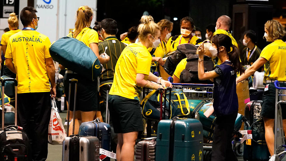 Pictured here, members of Australia's Olympic team after arriving in Tokyo for the Games.