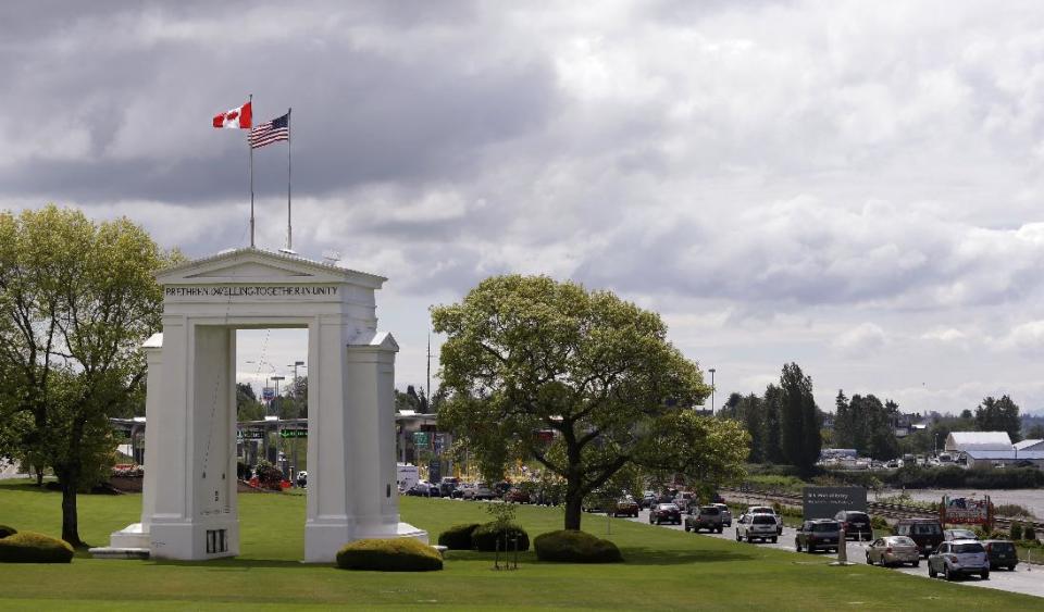 In this Thursday, May 23, 2013 photo, cars from Canada line up to cross into the United States, in Blaine, Wash., at Peace Arch State Park. In April 2013, in its 2014 fiscal year budget proposal, the Department of Homeland Security requested permission to study a fee at the nation's land border crossings. The request has sparked wide opposition among members of Congress from northern states, who vowed to stop it. A fee, they say, would hurt communities on the border that rely on people, goods and money moving between the U.S. and Canada. (AP Photo/Elaine Thompson)