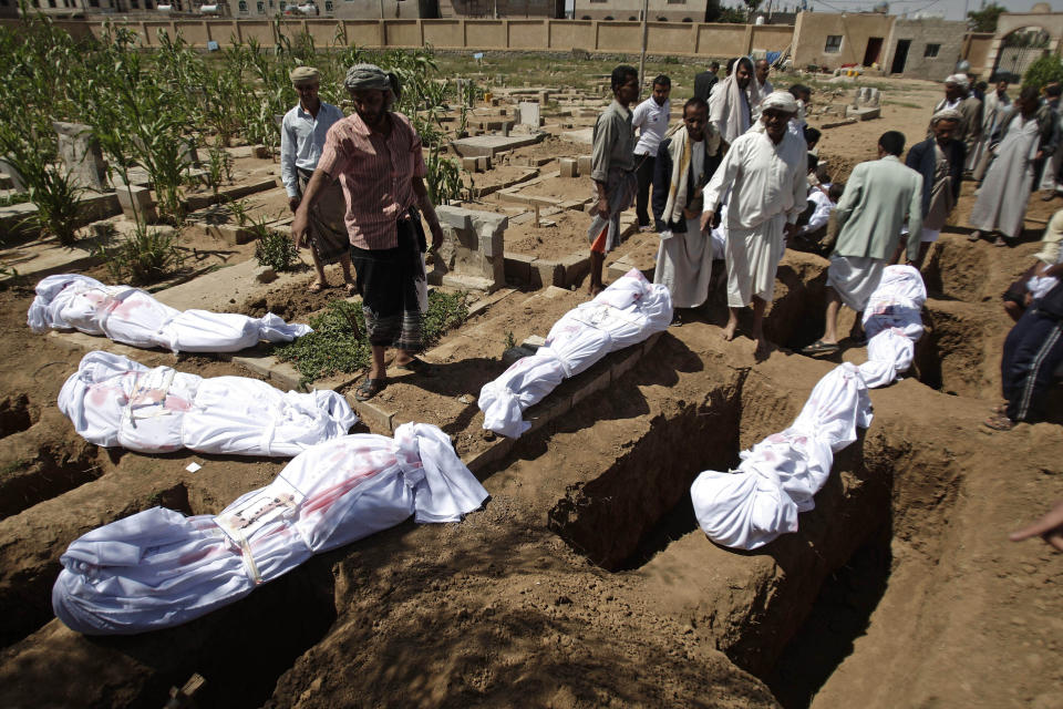 File - In this Friday, Aug. 17, 2012 file photo, Yemeni volunteers prepare to bury the bodies of unidentified people who were killed during the last year's clashes between government forces and tribal militants at a mass funeral in Sanaa, Yemen.Ten years ago, an uprising in Tunisia opened the way for a wave of popular revolts against authoritarian rulers across the Middle East known as the Arab Spring. For a brief window as leaders fell, it seemed the move toward greater democracy was irreversible. Instead, the region saw its most destructive decade of the modern era. Syria, Yemen, Libya and Iraq have been torn apart by wars, displacement and humanitarian crisis. (AP Photo/Hani Mohammed, File)