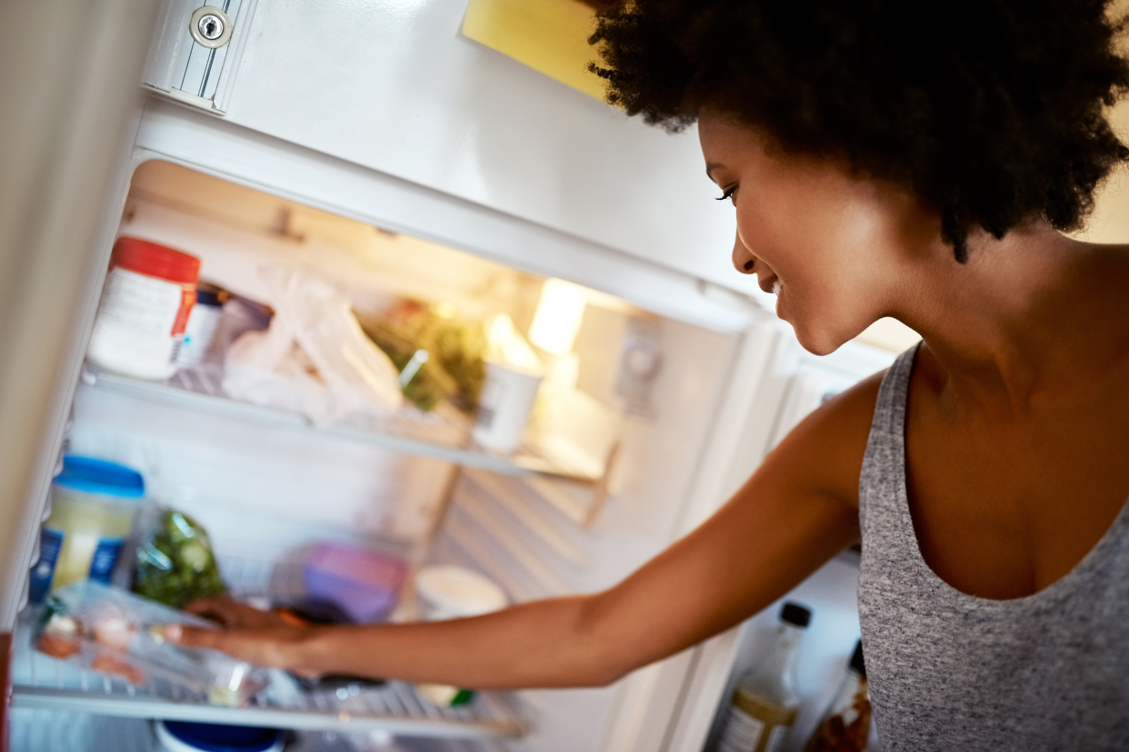 Woman looking in her refrigerator