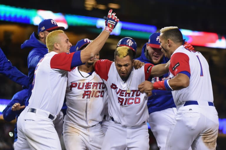 Eddie Rosario of Puerto Rico celebrates with teammates after getting the game-winning hit in the 11th inning for a 4-3 win over the Netherlands, at Dodger Stadium in Los Angeles, on March 20, 2017