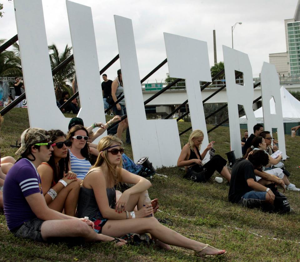 Concertgoers at the 2009 Ultra Music Festival sit on a hill as they listen to music in Miami.