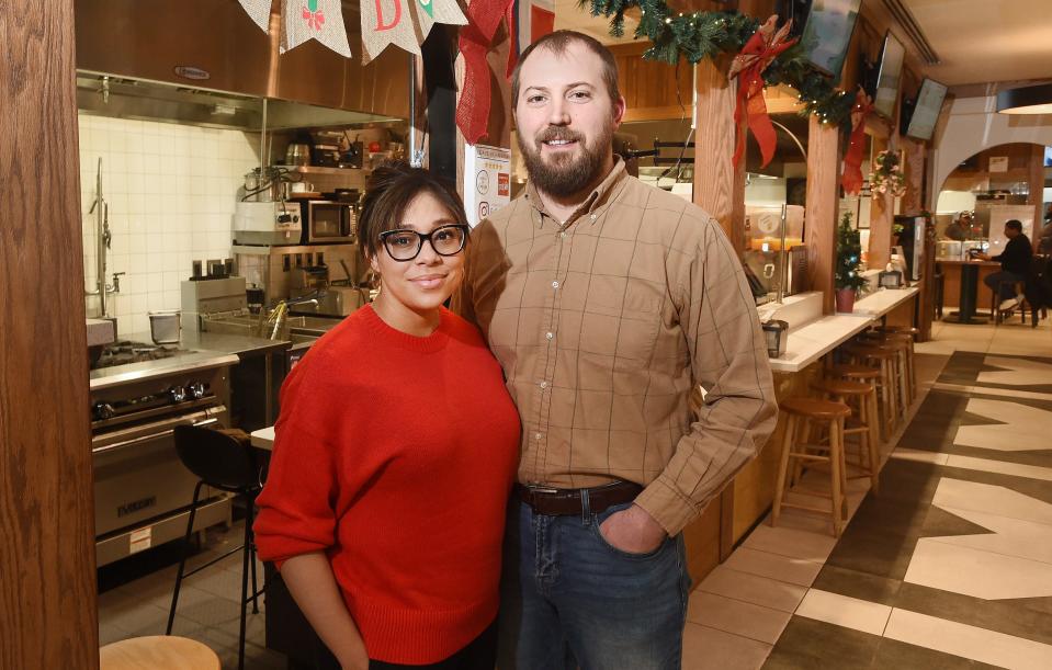 Dina Csir, 32, and her husband John Csir, 35, who own and operate Dina's Authentic Dominican Kitchen, are shown inside the Flagship City Food Hall in Erie.