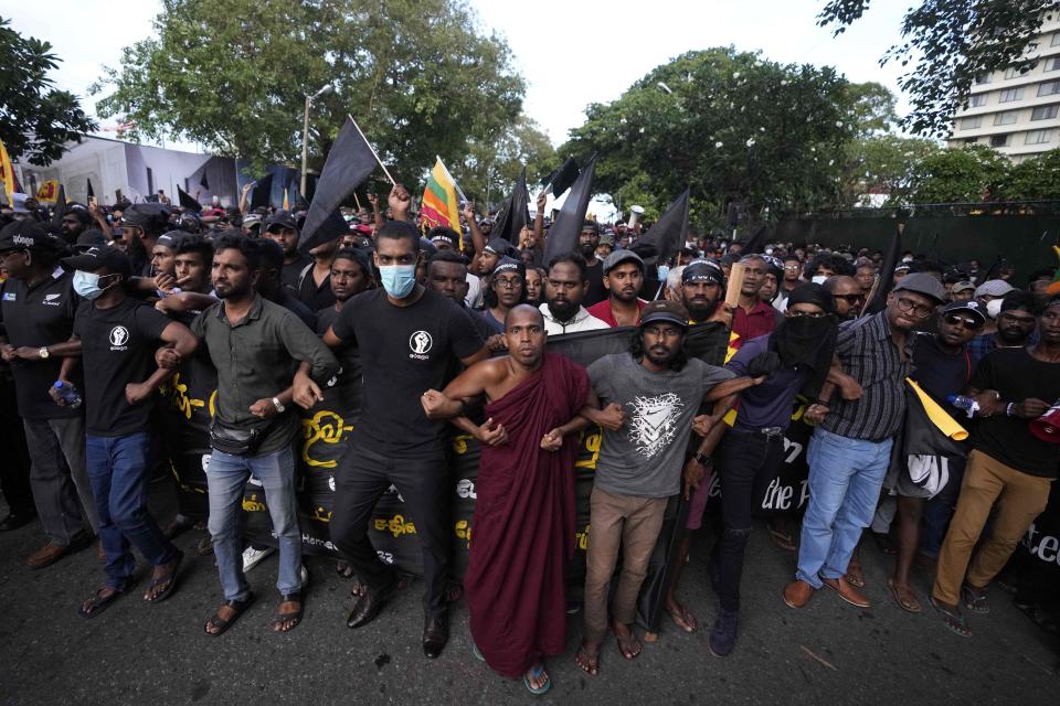 Anti government protesters march near the president's official residence in Colombo, Sri Lanka, Saturday, May 28, 2022. Police fired tear gas and water canon on protesters who marched toward the president Gotabaya Rajapaksa's barricaded residence demanding his resignation. (AP Photo/Eranga Jayawardena)