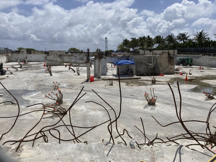 FILE - The site where the Champlain Towers South collapsed killing 98 people is shown on April 14, 2022, in Surfside, Fla. A judge has given final approval Thursday, June 23, 2022, to a settlement of more than $1 billion for victims of the collapse of a Florida beachfront condominium. Ninety-eight people died when the 12-story Champlain Towers South suddenly collapsed. The decision comes one day before the one-year anniversary of the disaster in the Miami suburb of Surfside. (AP Photo/Wilfredo Lee, File)