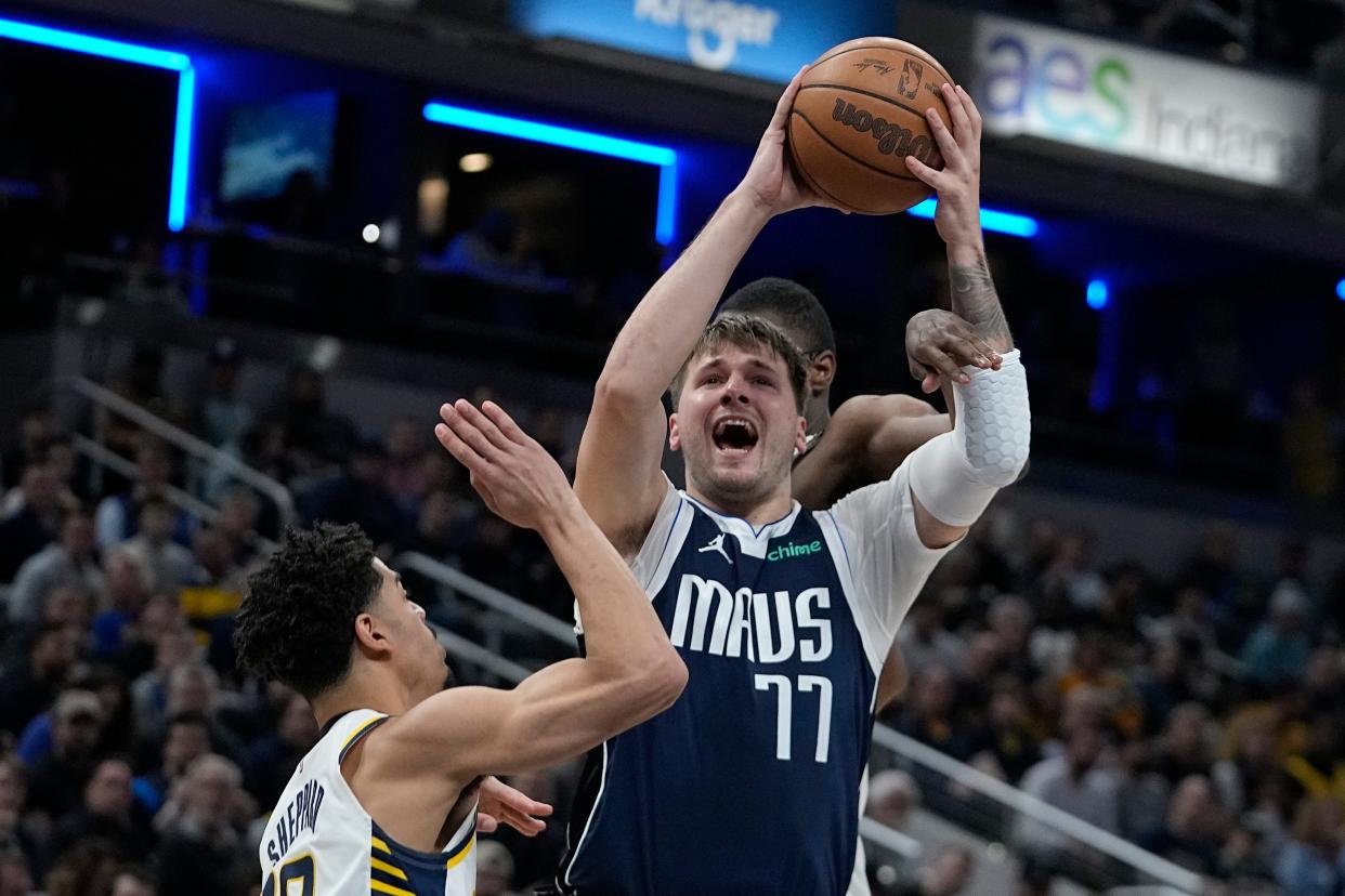 Dallas Mavericks' Luka Doncic (77) slooks to shoot against Indiana Pacers' Ben Sheppard, left, during the first half of an NBA basketball game, Sunday, Feb. 25, 2024, in Indianapolis. (AP Photo/Darron Cummings)