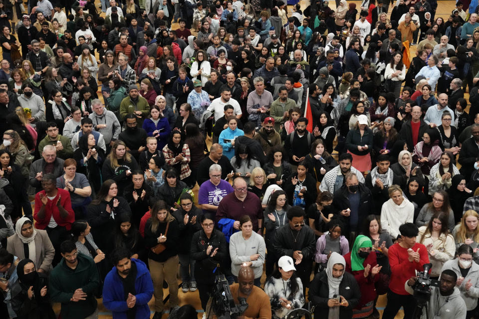 Mourners hold candles for Wadea Al Fayoume, a 6-year-old Muslim boy killed in an alleged hate crime during a vigil at Prairie Activity and Recreation center in Plainfield, Ill., late Tuesday, Oct. 17, 2023. (AP Photo/Nam Y. Huh)