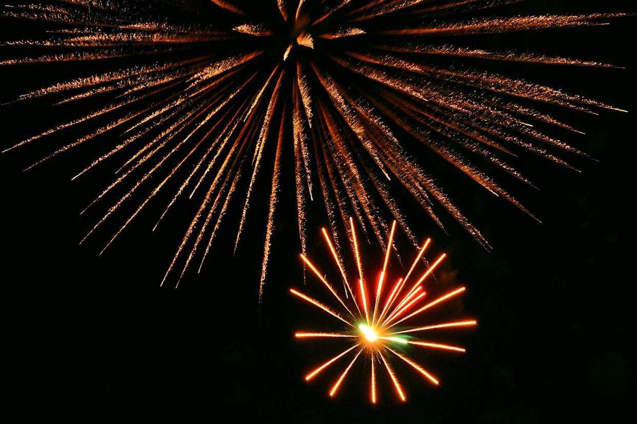 Fireworks burst above the crowd in Hope Mills on Saturday, July 4, 2015.