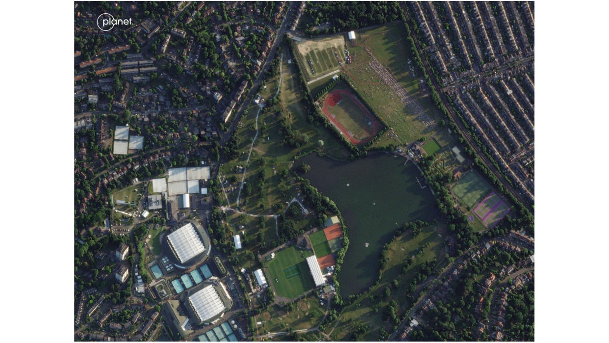  satellite image of wimbledon from space, showing the tennis courts interspersed with grass, trees and roads 