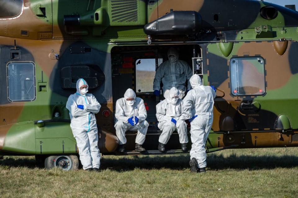 French medics wait for a German ambulance to arrive to transport two French patients infected with the coronavirus Covid-19 at a small airport near Nordhausen, eastern Germany on April 2, 2020. Source: JENS SCHLUETER/AFP via Getty Images