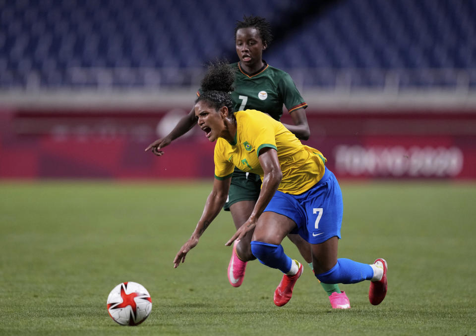 Brazil's Duda, front, is fouled by Zambia's Ochumba Lubandji during a women's soccer match at the 2020 Summer Olympics, Tuesday, July 27, 2021, in Saitama, Japan. (AP Photo/Martin Mejia)