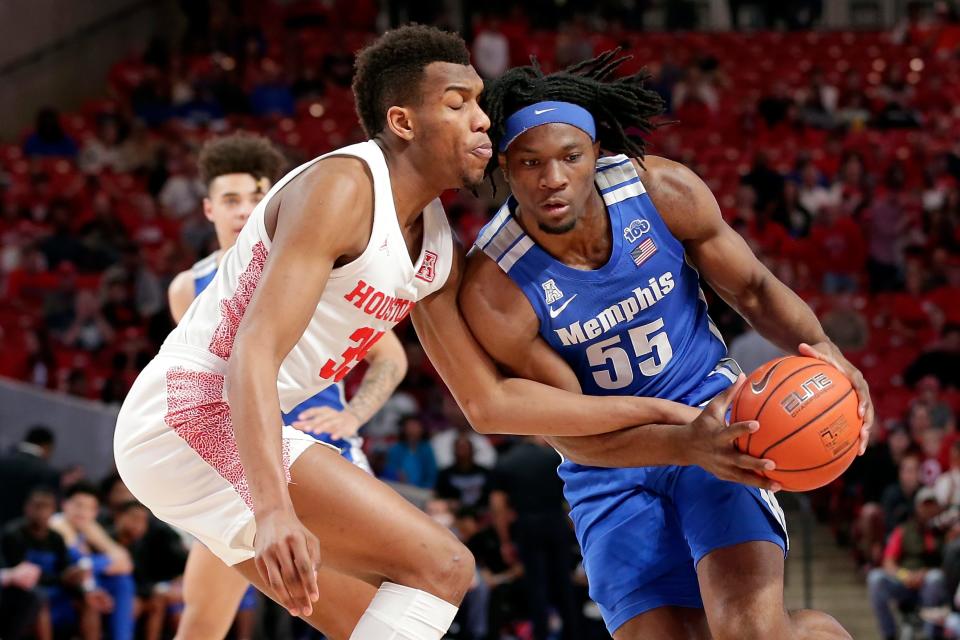 Houston forward Fabian White Jr. (35) reaches in as Memphis forward Precious Achiuwa (55) drives to the basket during the first half of an NCAA college basketball game Sunday, March 8, 2020, in Houston. (AP Photo/Michael Wyke).