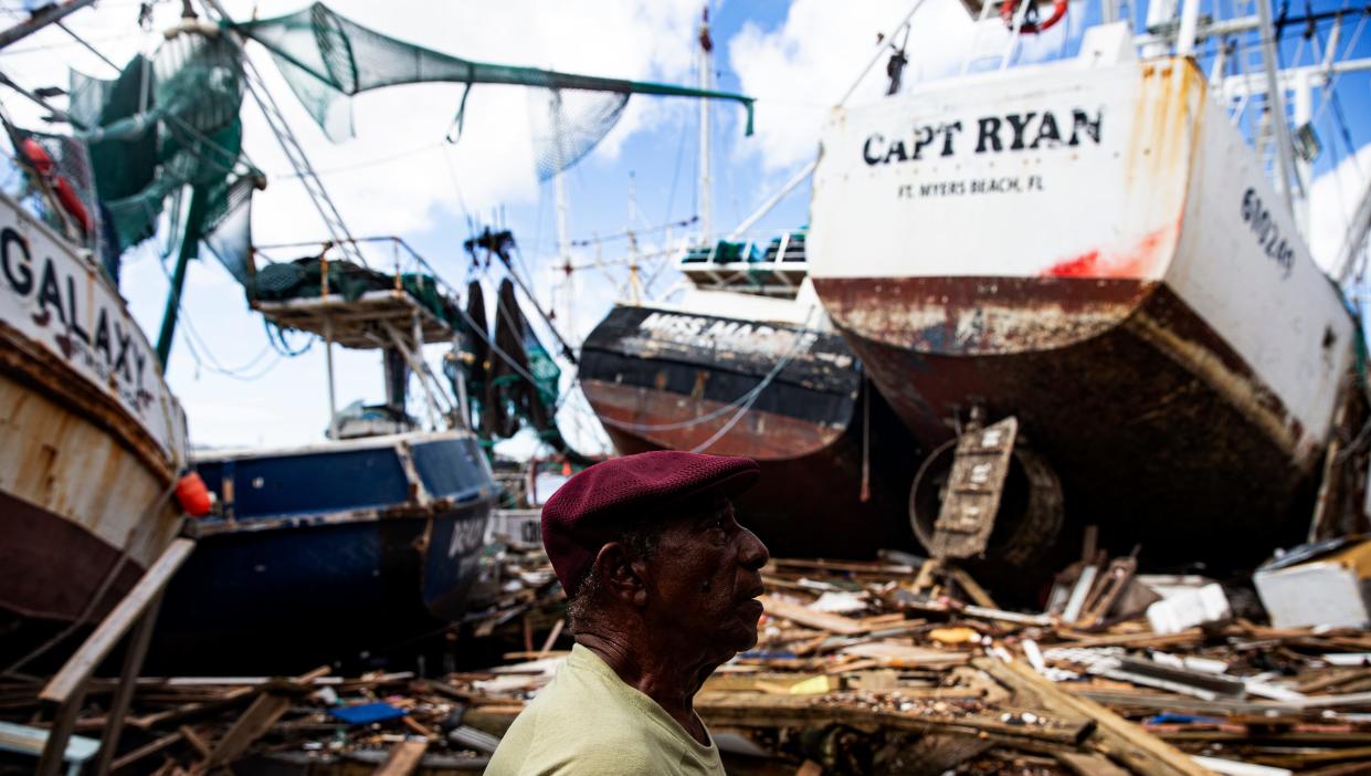 Two weeks after Hurricane Ian, Leonard Hunte, 77, a lifelong shrimper, surveys damage to shrimp boats that were washed ashore by storm surge from the category 4 hurricane. A just-introduced bill could help Southwest Florida’s fishing families recover from natural disasters more quickly.