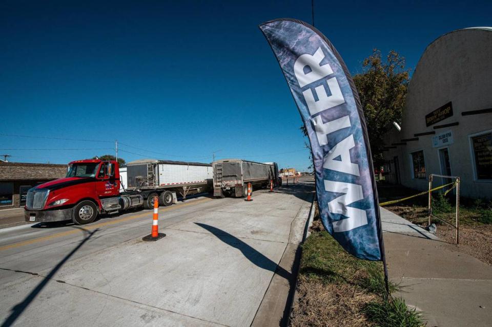 A steady stream of grain trucks rolled through Scott City, Kansas, past a sign for a purified water kiosk in mid-October during the corn harvest season. Scott County has some of the most depleted water deposits in the Ogallala Aquifer in Kansas.