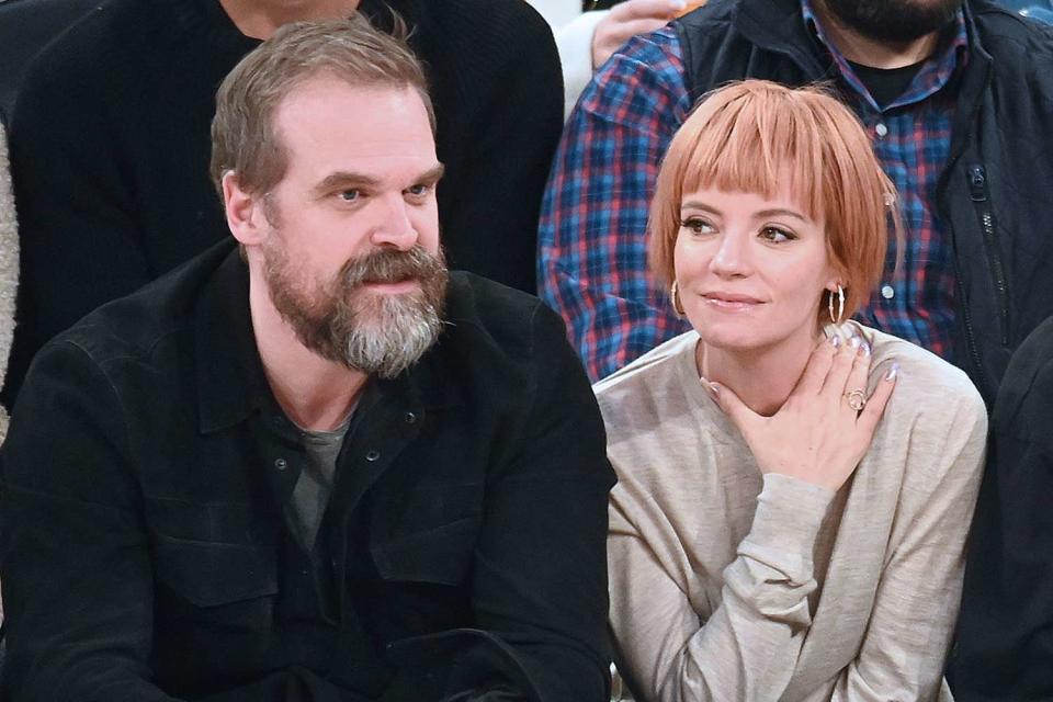 <p>Michael Simon/Shutterstock</p> David Harbour and Lily Allen watch the New York Knicks at Madison Square Garden 