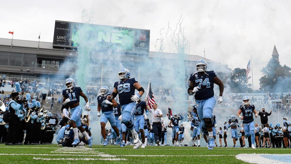 North Carolina football players, including linebacker RaRa Dillworth (11), defensive back Trey Morrison (4), offensive lineman Brian Anderson (68), offensive lineman Jordan Tucker (74) and kicker Grayson Atkins (17), take the field before last month’s victory against Wake Forest.