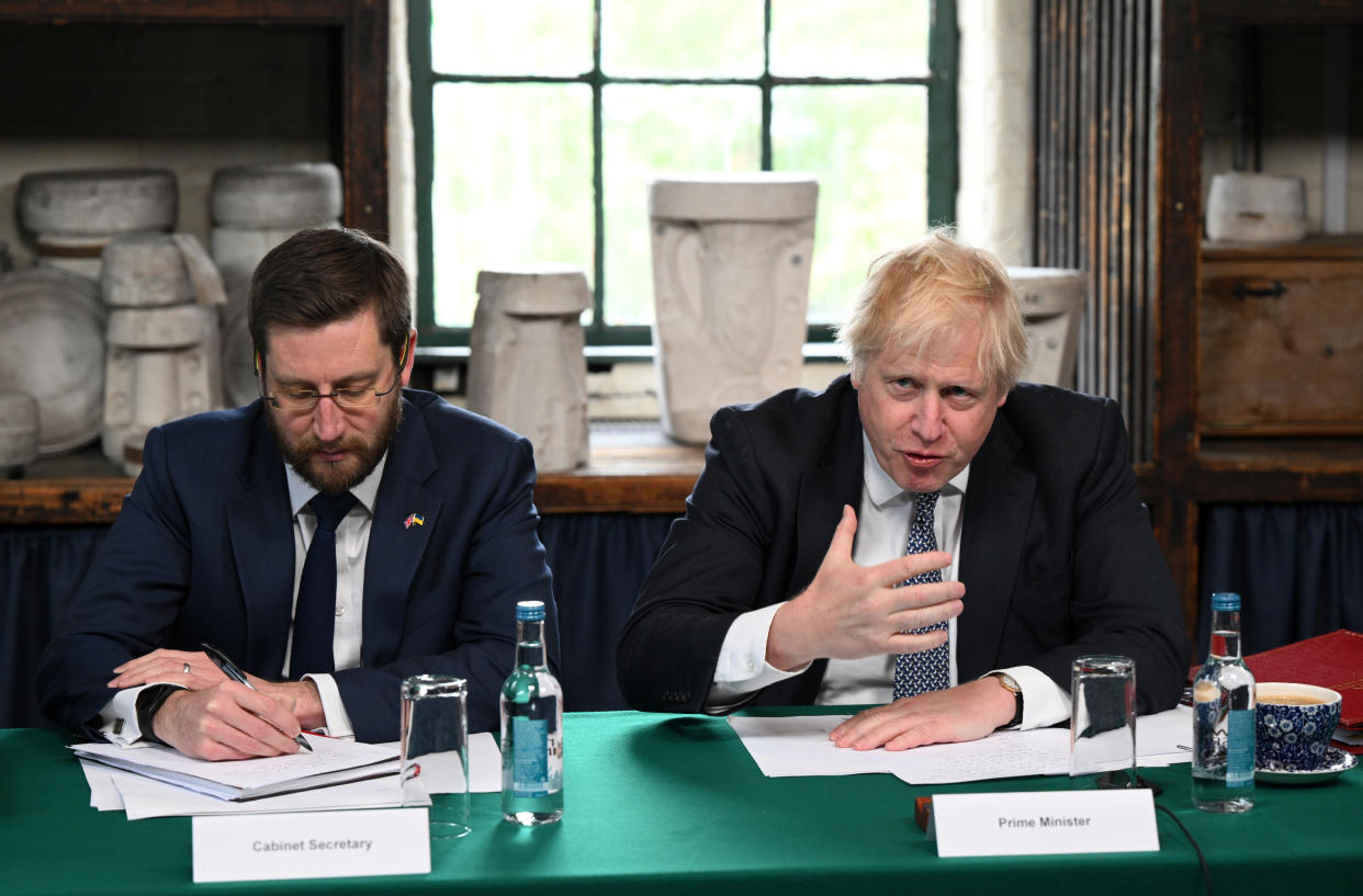 Prime Minister Boris Johnson (right) and Cabinet Secretary Simon Case during a regional cabinet meeting at Middleport Pottery in Stoke on Trent. Picture date: Thursday May 12, 2022.