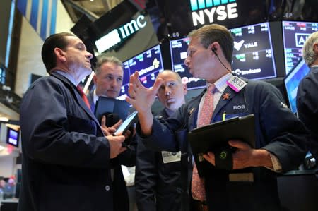 FILE PHOTO: Traders work on the main trading floor after opening bell at New York Stock Exchange (NYSE) in New York