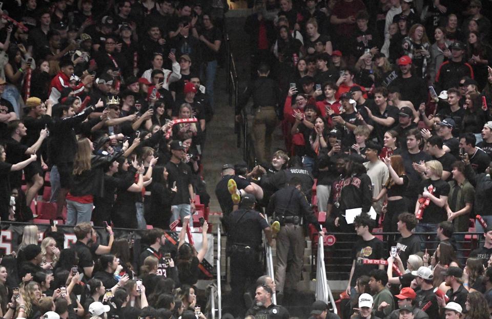 A Texas Tech fan is carried out of United Supermarkets Arena during the Big 12 basketball game against Texas, Tuesday, Feb. 27, 2024, at United Supermarkets Arena.