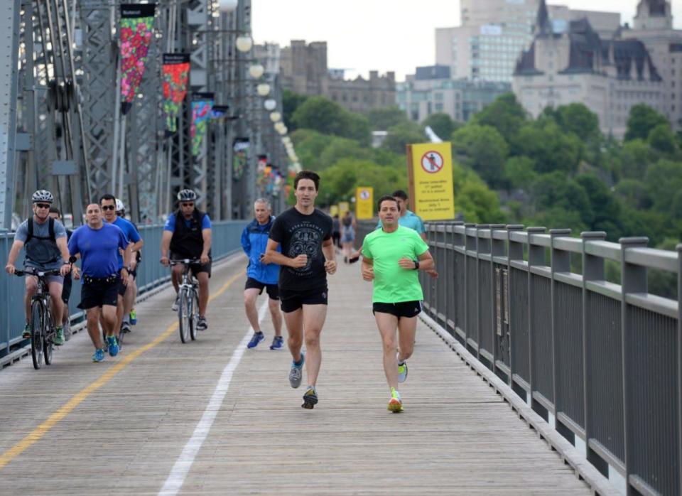 Prime Minister Justin Trudeau and Mexican President Enrique Pena Nieto run across the Alexandra Bridge from Ottawa to Gatineau, Quebec on Tuesday, June 28, 2016. THE CANADIAN PRESS/Sean Kilpatrick