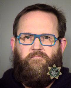 In this photo released by the Multnomah County Sheriff's Office shows John E. Brennan. Port of Portland police say Brennan, 49, stripped naked at Portland International Airport as a protest against airport security screeners. The incident report said John E. Brennan's actions Tuesday evening caused some passengers to cover their eyes and their children's eyes while others looked, laughed and took photos. Police say the Portland man was arrested for investigation of indecent exposure and disorderly conduct. The Oregonian reports the Port of Portland summary said Brennan "disrobed completely naked" while going through a security screening area. He later told authorities he flies often and "disrobed as a form of protest against TSA (Transportation Security Administration) screeners he felt were harassing him." He missed his flight to San Jose, Calif. (AP Photo/Multnomah County Sheriff's Office) ___