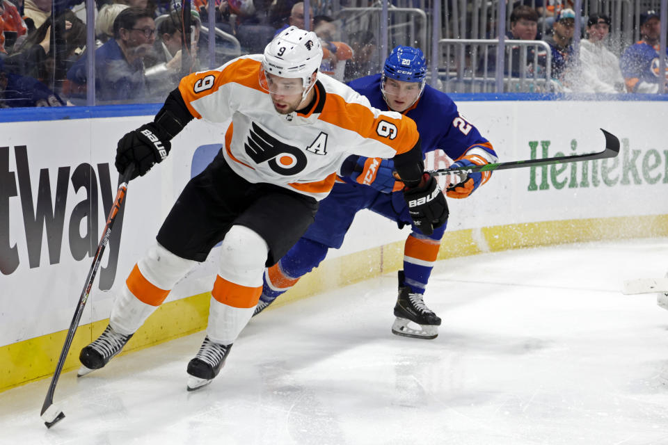 Philadelphia Flyers defenseman Ivan Provorov (9) is pursued by New York Islanders left wing Kieffer Bellows (20) during the second period of an NHL hockey game, Tuesday, Jan. 25, 2022, in Elmont, N.Y. (AP Photo/Corey Sipkin).