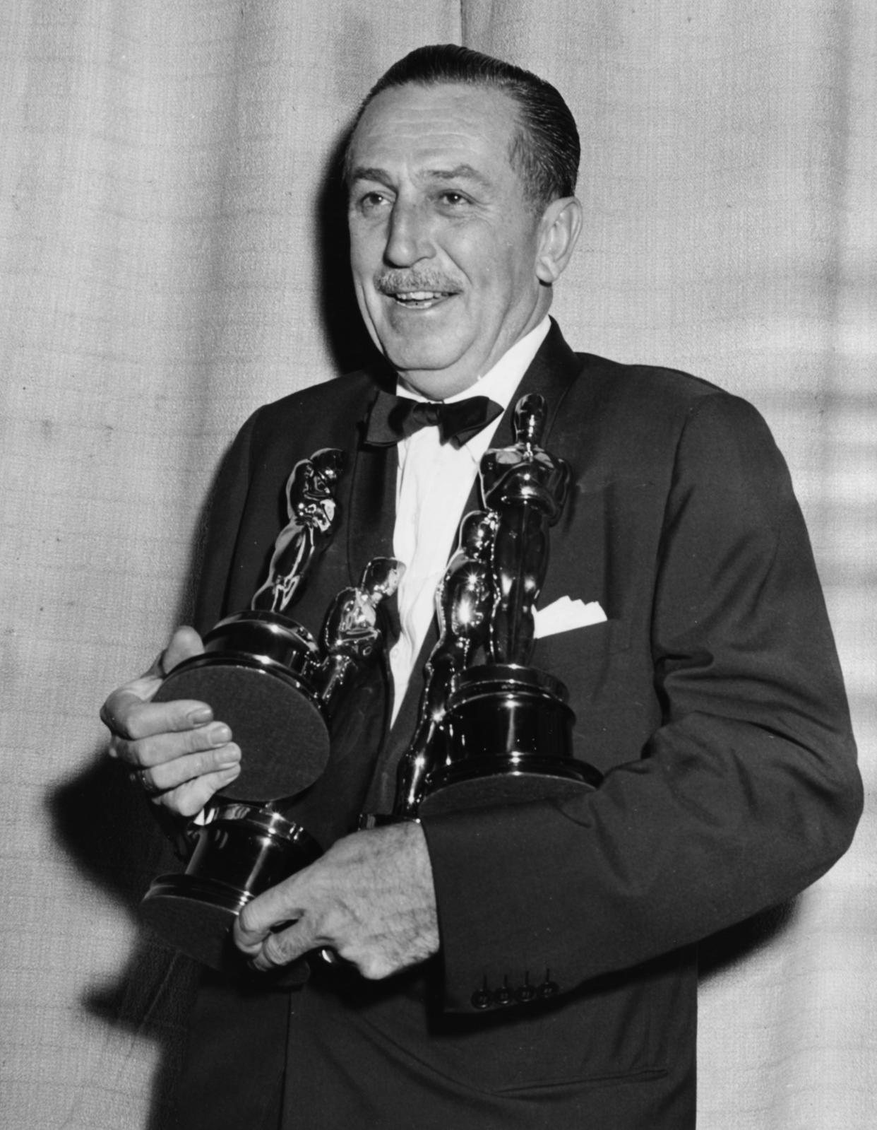 Film maker Walt Disney holding his four Oscars, for four different films, at the 26th Academy Awards, March 25th 1954. / Credit: Archive Photos / Getty Images