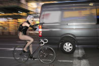 In this Saturday, May 2, 2020 photo, a woman rides her bike through New York's Times Square during the coronavirus pandemic. (AP Photo/Mark Lennihan)