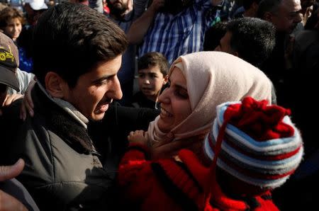 A relative reacts as she stands next to one of the hostages who escaped from his Islamic State captors in Qaryatayn town in Homs province, Syria October 29, 2017. REUTERS/Omar Sanadiki