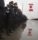 Police officers line the road while waiting for the hearse to arrive at the public memorial for police constable John Zivcic in Toronto December 9, 2013. Zivcic died December 2, from injuries he sustained in a car crash while in pursuit of another vehicle. He was Toronto's 26th officer to die while on duty since the Toronto police force began in 1957. REUTERS/Fred Thornhill (CANADA - Tags: OBITUARY CRIME LAW)