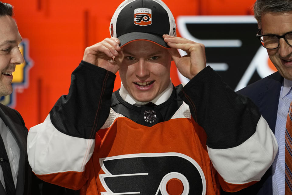 Matvei Michkov adjust his Philadelphia Flyers hat after being picked by the team during the first round of the NHL hockey draft Wednesday, June 28, 2023, in Nashville, Tenn. (AP Photo/George Walker IV)