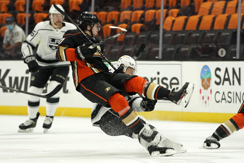 Anaheim Ducks defenseman Ben Hutton, top, and Los Angeles Kings right wing Dustin Brown collide during the first period of an NHL hockey game Monday, March 8, 2021, in Anaheim, Calif. (AP Photo/Mark J. Terrill)
