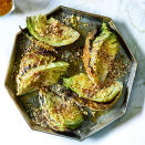 <p>Easy Savoy cabbage recipes can be far and few between, especially ones that are as delicious as this whole roasted cabbage. The outer cabbage leaves blacken during the long cooking time, but when removed they reveal a meltingly tender center. Orange blossom water adds delicate aroma to the vinaigrette that's drizzled on top. Serve alongside roast beef or pork, or over mashed potatoes as a main course. <a href="https://www.eatingwell.com/recipe/276416/roasted-savoy-cabbage-with-orange-vinaigrette/" rel="nofollow noopener" target="_blank" data-ylk="slk:View Recipe;elm:context_link;itc:0;sec:content-canvas" class="link ">View Recipe</a></p>