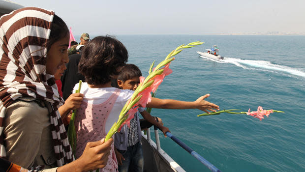 Iranian children throw flowers into the sea as they commemorate the 24th anniversary of the downing of Iran Air Flight 655 by the U.S. Navy, at the port of Bandar Abbas, Iran, July 2, 2012. / Credit: ATTA KENARE/AFP/Getty