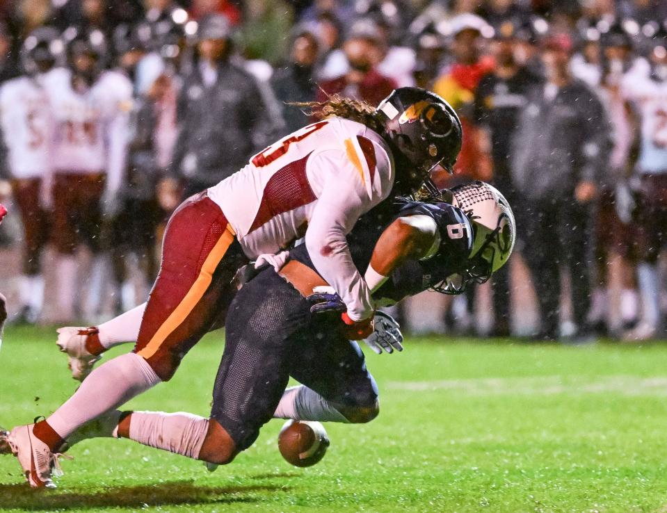 1Central Valley Christian's Bryson Donelson fumbles under pressure from Tulare Union's Dominic Wilson in a CIF Central Section Division II football championship semifinal Friday, November 17, 2023.