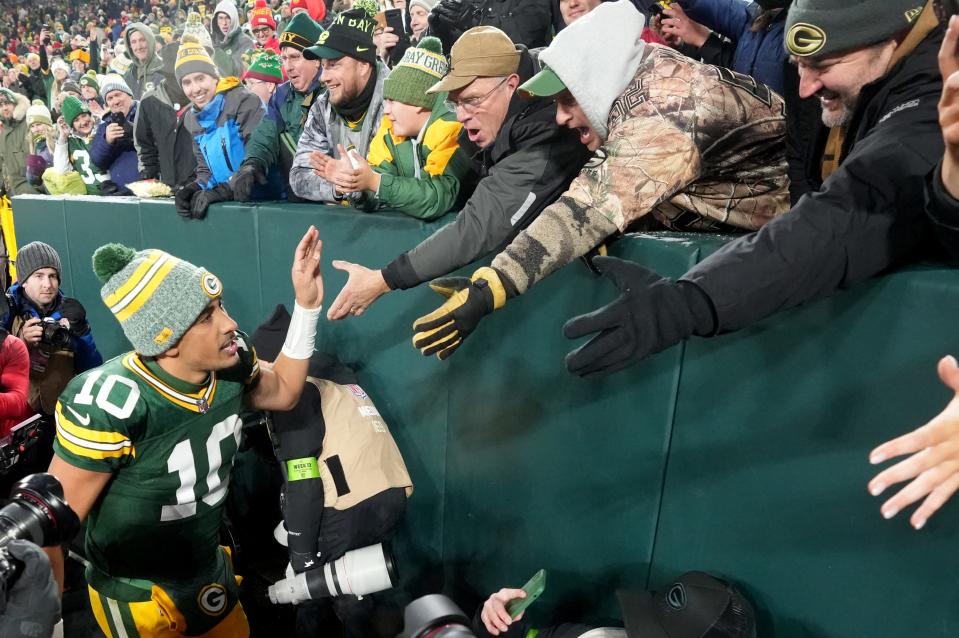 Jordan Love greets fans after throwing three touchdowns to lead the Green Bay Packers to a 27-19 victory over the Kansas City Chiefs on Sunday.