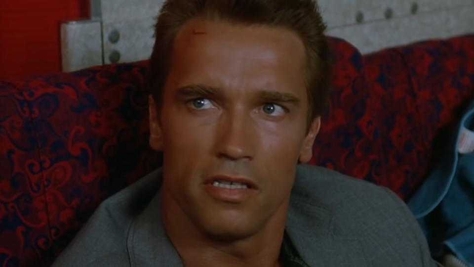 Arnold Schwarzenegger sits in an airplane in Commando