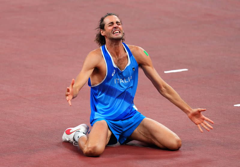 Foto del domingo del italiano Gianmarco Tamberi celebrando tras el oro compartido en salto en alto con el qatarí Mutaz Essa Barshim