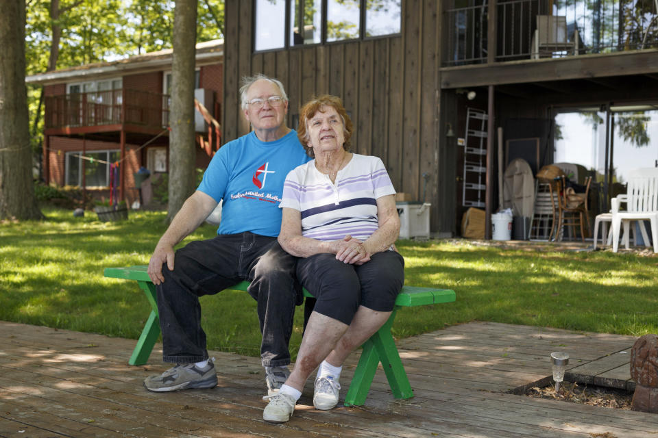 Mike and Judy Gorthy sit in their backyard which reaches to the edge of the nearly empty Sanford Lake on June 2, 2020, in Sanford, Mich. (Elaine Cromie / for NBC News)