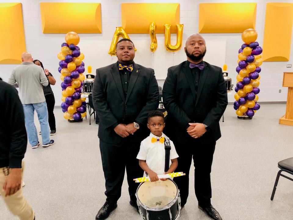 Jeremiah Travis, 5, is an instrumental part of the band at St. Helena College and Career Academy in Greensburg, La. Chesteron Frye, left, and Brandon Dorsey serve as the band director and percussion instructor respectively.