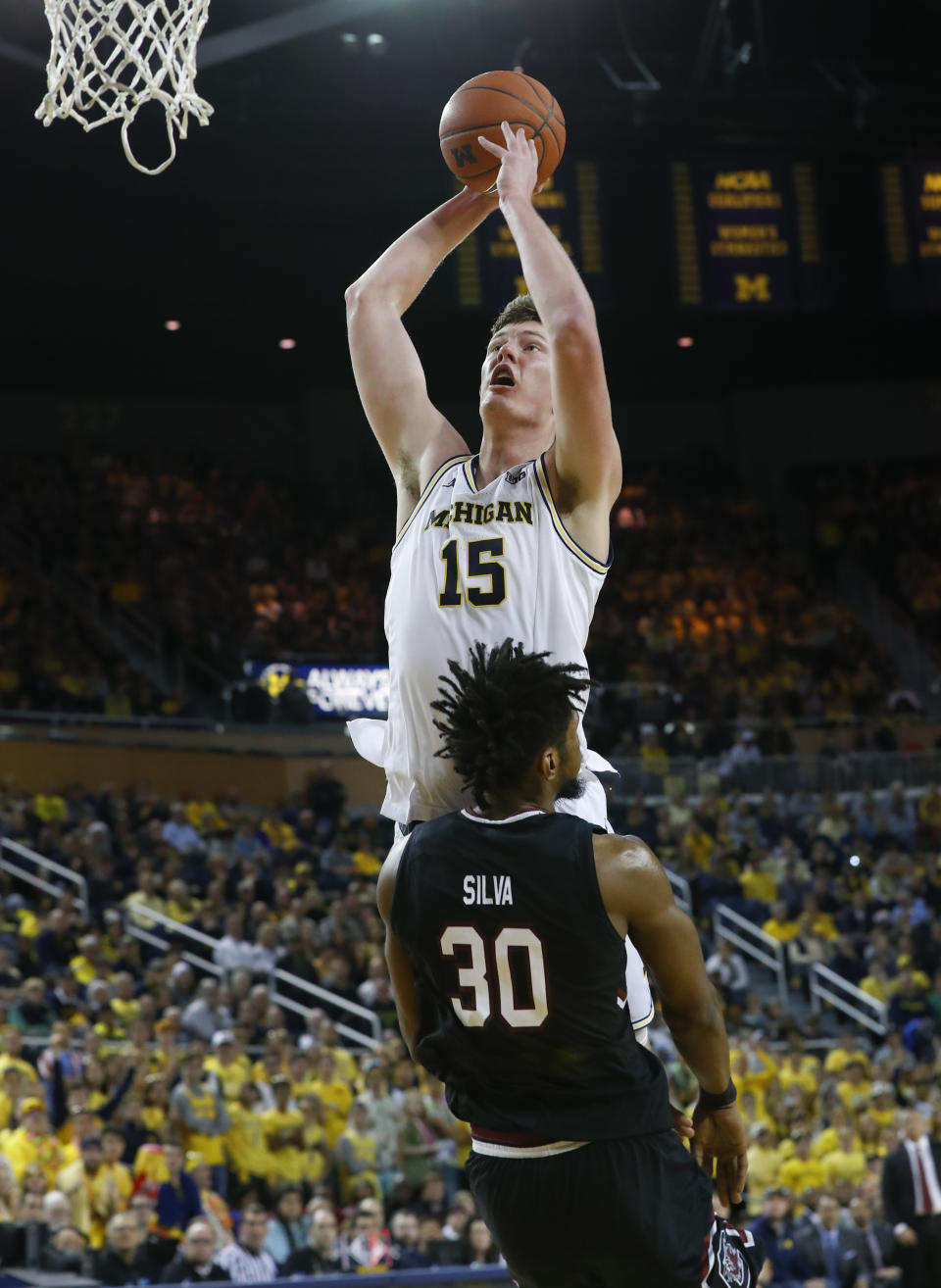 Michigan center Jon Teske (15) shoots over South Carolina forward Chris Silva (30) during the second half of an NCAA college basketball game in Ann Arbor, Mich., Saturday, Dec. 8, 2018. (AP Photo/Paul Sancya)