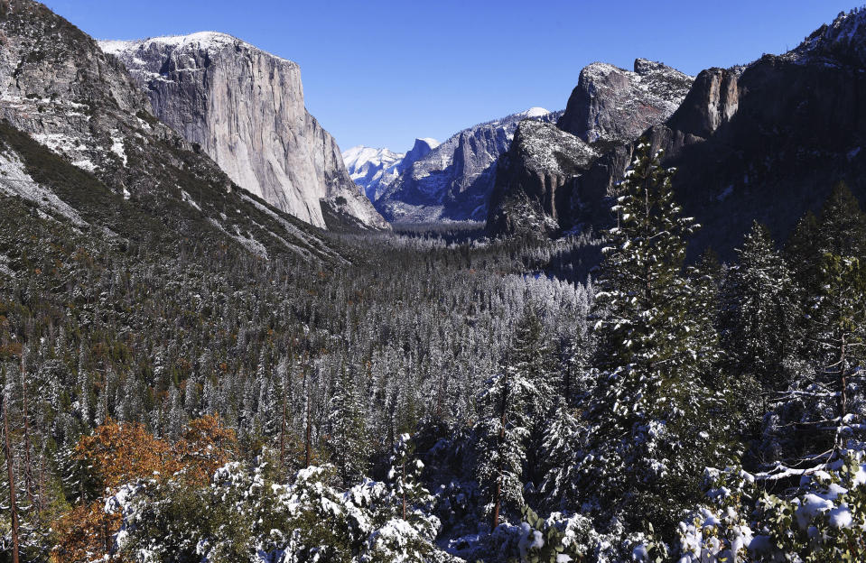 FILE - A light dusting of snow covers Yosemite Valley in this Monday, Nov. 9, 2020, file photo following a weekend snowstorm in Yosemite National Park, Calif. Yosemite National Park will require advanced reservations for day visitors this summer, the park's peak tourist season, to limit the number of visitors and allow social distancing amid the coronavirus outbreak. Under the new rules, advance reservations will be required for day use visitors who enter Yosemite from May 21, 2021 to Sept. 30, 2021, the San Jose Mercury News reported. (Eric Paul Zamora/The Fresno Bee via AP,File)