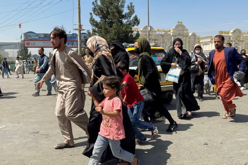 FILE PHOTO: People try to get into Hamid Karzai International Airport in Kabul