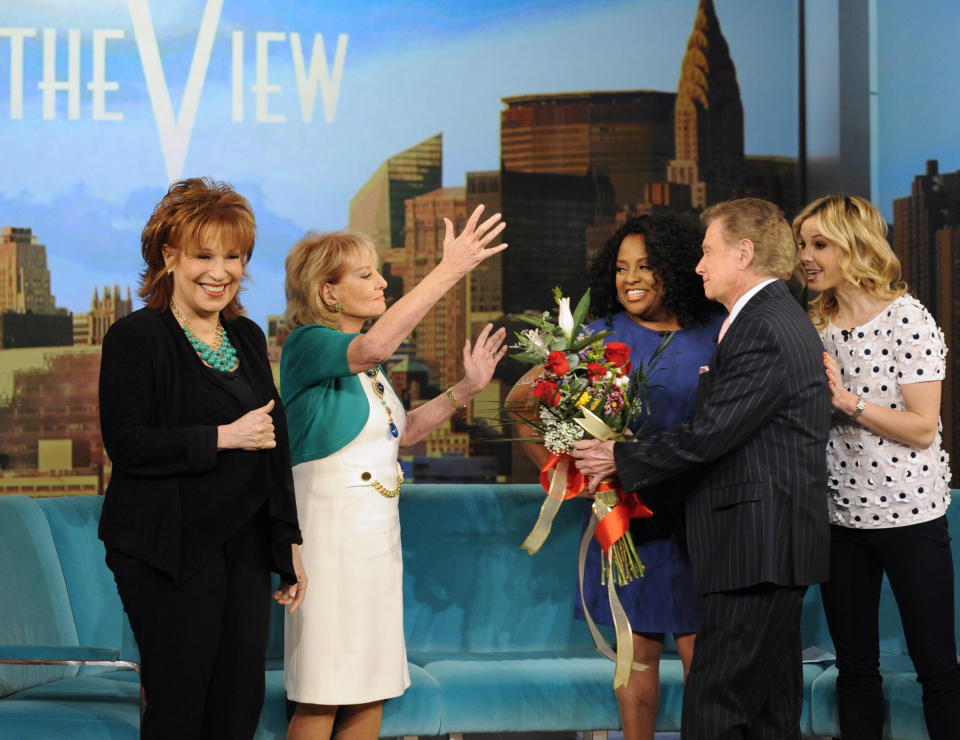 This image released by ABC shows Barbara Walters, second left, receiving flowers from Regis Philbin, second right, on her first day back to "The View," in New York on Monday, March 4, 2013, after being sidelined for six weeks by chickenpox and a concussion. Looking on are co-hosts Joy Behar, left, Sherri Shepherd and Elisabeth Hasselbeck, right. (AP Photo/ABC, Donna Svennevik)