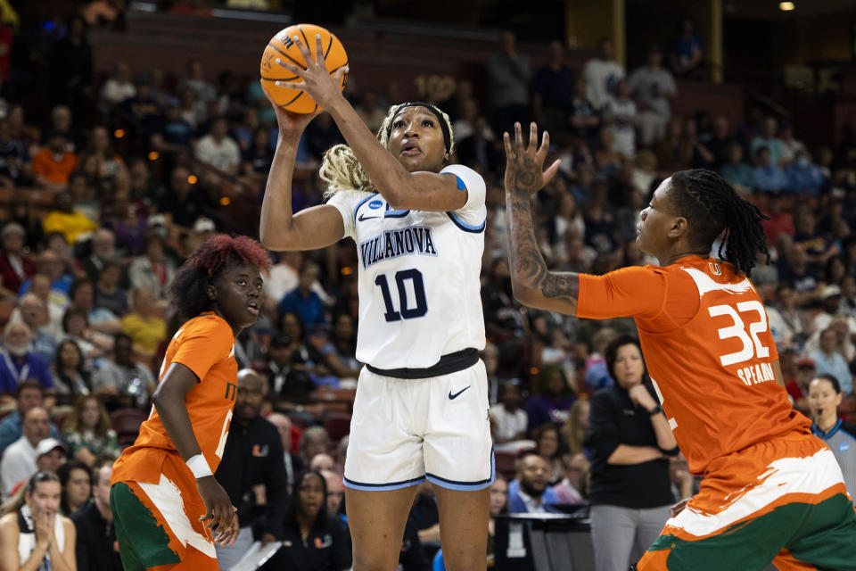 Villanova's Christina Dalce (10) shoots against the defense of Miami's Lazaria Spearman (32) in the first half of a Sweet 16 college basketball game of the NCAA Tournament in Greenville, S.C., Friday, March 24, 2023. (AP Photo/Mic Smith)